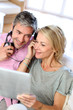 Couple listening to music at home with tablet