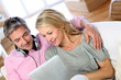 Couple listening to music at home with tablet