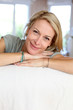 Beautiful blond mature woman relaxing in sofa