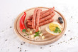 wooden chopping board with sausages,  cheese, bread and mustard