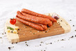 wooden chopping board with sausages and spices
