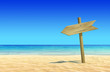 Empty wooden signpost on idyllic tropical sand beach