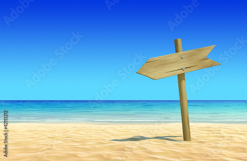 Photo: Empty wooden signpost on idyllic tropical sand beach Empty wooden signpost on idyllic tropical sand beach