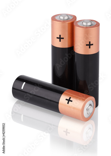 Photo: Closeup of three AA batteries on white Closeup of three AA batteries on white