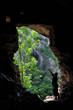 Foto: Man standing in front of a cave entrance Man standing in front of a cave entrance