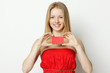 Young smiling woman holding blank credit card
