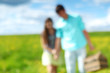 man and woman walk on picnic