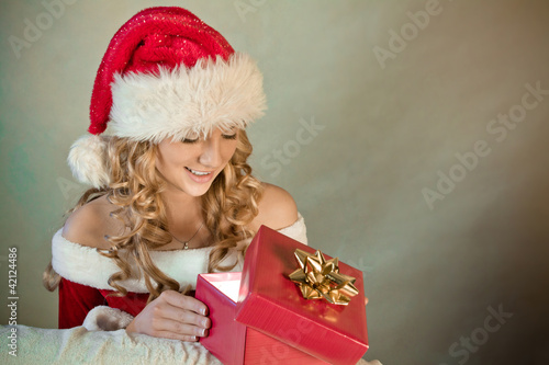 Photo: Portrait of a beautiful woman in santa hat smiling Portrait of a beautiful woman in santa hat smiling