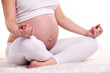 Young pregnant woman sitting in a lotus position