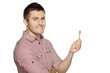 Photo: Young man holding house key isolated over white Young man holding house key isolated over white