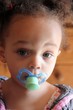 Ethnic girl with a dummy or pacifier