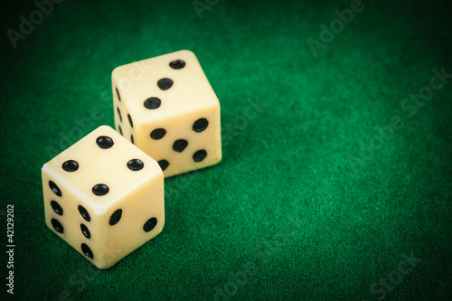 Photo: Two dice on a green gaming table with space for text Two dice on a green gaming table with space for text