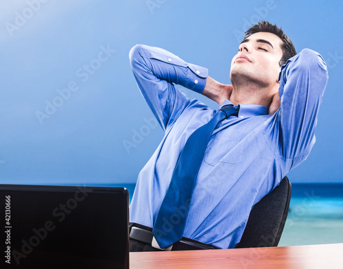 Photo: Businessman dreaming holiday Businessman dreaming holiday