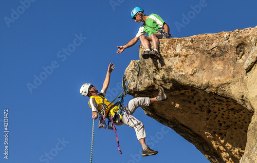 Photo: Climbing team struggles to the summit. Climbing team struggles to the summit.