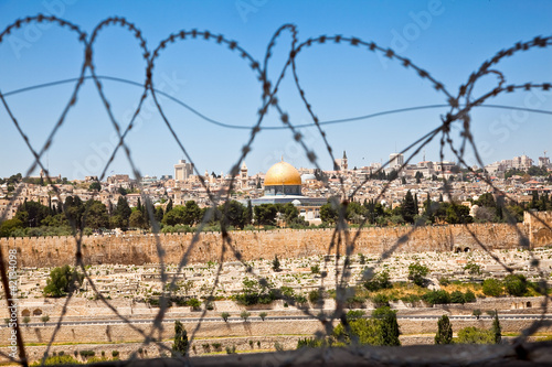 Photo: The Old City of Jerusalem seen through coils of razor wire The Old City of Jerusalem seen through coils of razor wire