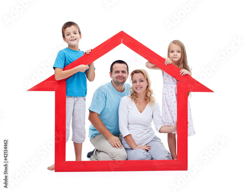 Photo: Young family with two kids holding house sign Young family with two kids holding house sign