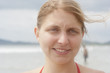 Young woman with blowing hair on beach