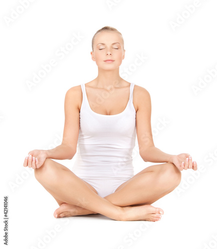 Photo: woman practicing yoga lotus pose woman practicing yoga lotus pose