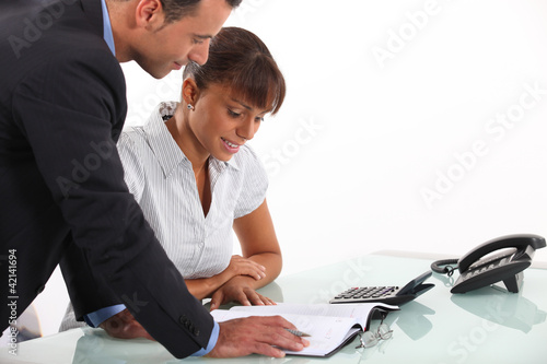 Photo: Secretary showing boss his schedule Secretary showing boss his schedule