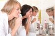 Three women brushing their teeth