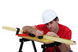 Carpenter marking wood before planing