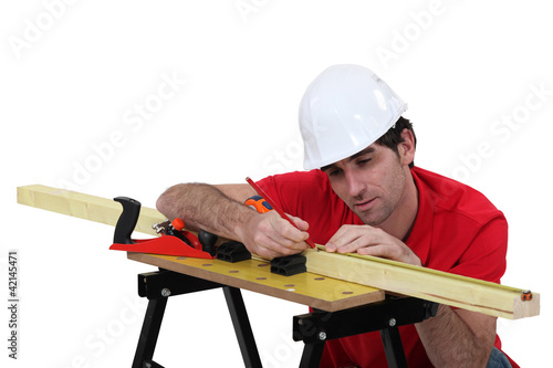 Photo: Carpenter marking wood before planing Carpenter marking wood before planing