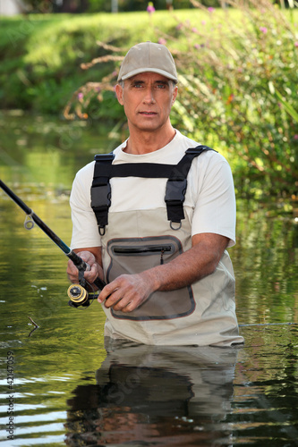 Photo: Fisherman wading in river Fisherman wading in river