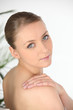 Young woman in a towel looking over her shoulder