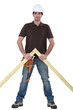 Carpenter stood with wooden truss