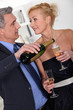 Mature couple drinking champagne