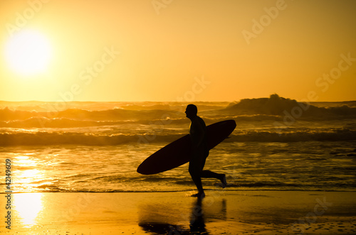 Photo: Surfer running Surfer running