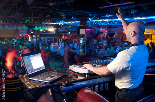 Photo: DJ behind the control panel DJ behind the control panel