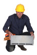 Tradesman holding a clinker block