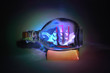 Small sailing boat in bottle on stand in dark