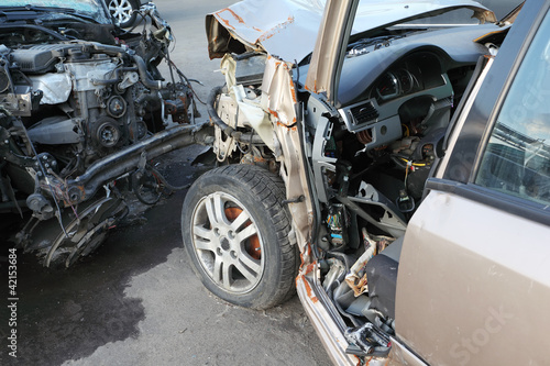 Photo: Crumpled and broken hoods of two collided cars after accident Crumpled and broken hoods of two collided cars after accident
