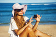 young woman with mobile phone on a beach, bali