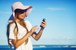 young woman with mobile phone on a beach, bali