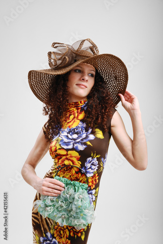 Photo: Pretty girl with a handbag and a hat. Pretty girl with a handbag and a hat.