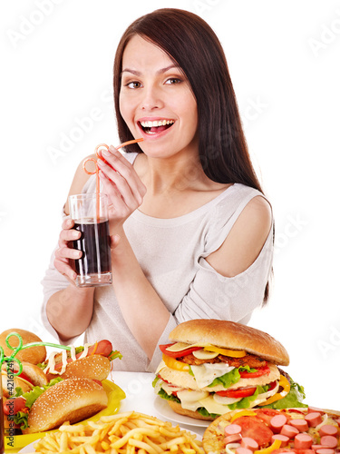 Foto: Woman eating fast food. Woman eating fast food.