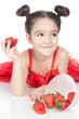 Little girl with strawberry on white background