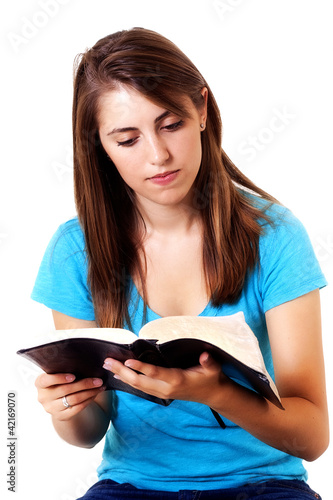 Photo: Young woman reading the Bible Young woman reading the Bible