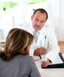 Doctor prescribing medication to patient