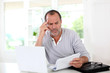Senior man being puzzled with tax documents