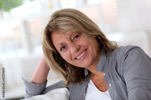 Photo: Senior woman at home sitting in sofa Senior woman at home sitting in sofa