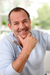 Portrait of senior man sitting in sofa at home
