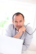 Senior businessman working on laptop from home