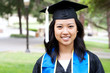 Beautiful young asian woman in graduation cap and gown