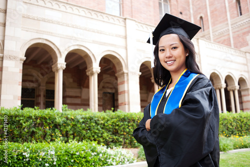 Photo: Beautiful young asian woman in graduation cap and gown Beautiful young asian woman in graduation cap and gown