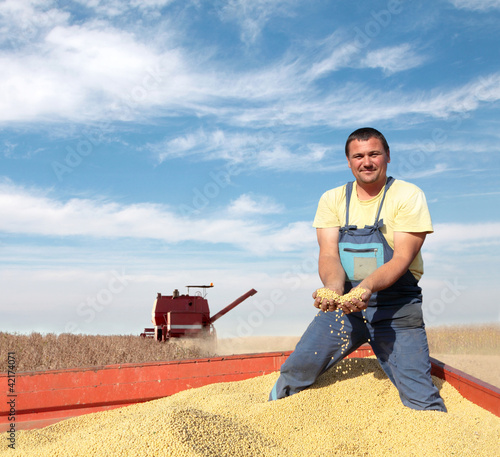 Photo: Agriculture, soybean harvesting farmer and combine Agriculture, soybean harvesting farmer and combine