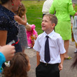 first-blond baby boy in a white shirt and tie, pants funny on th